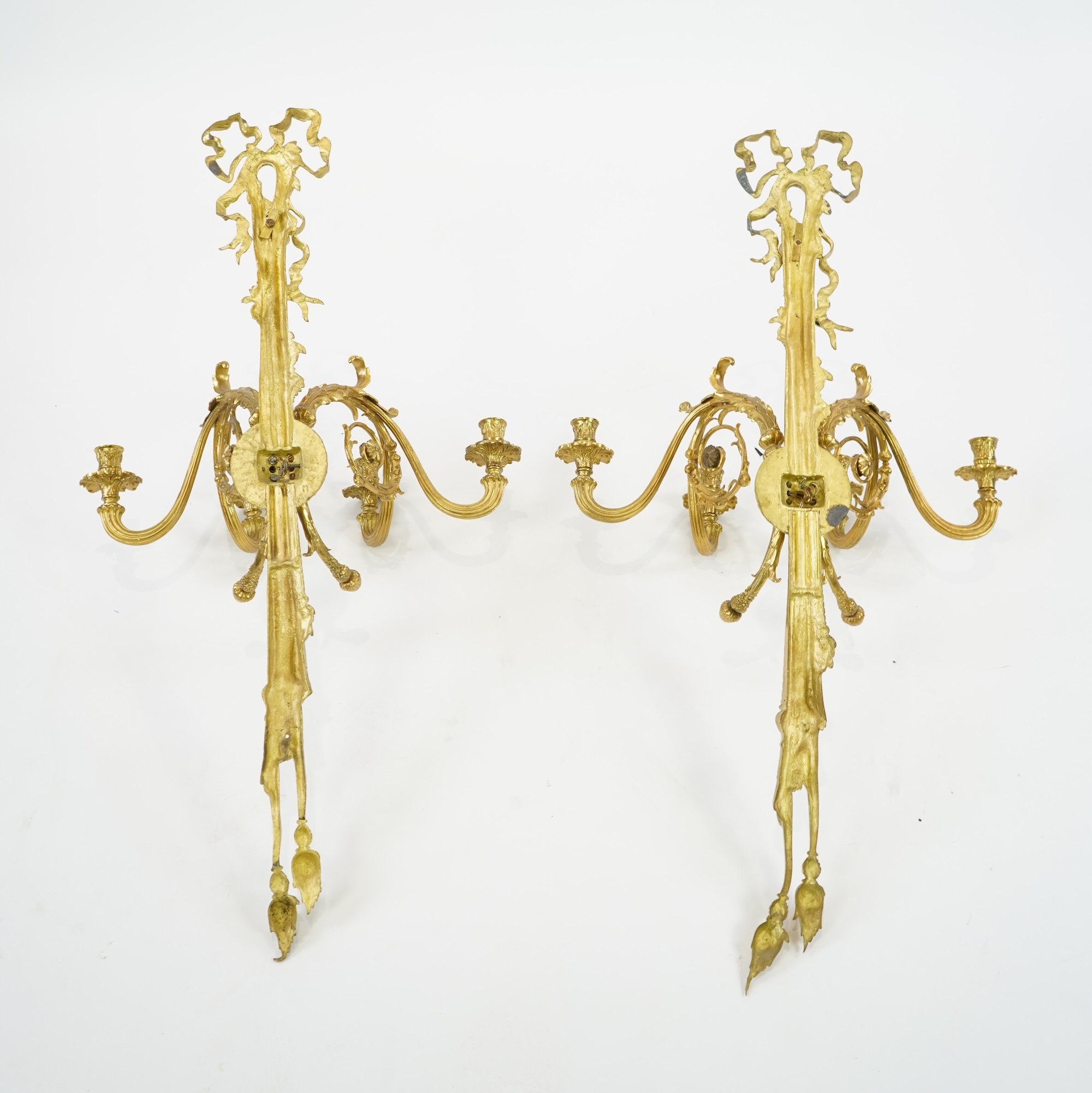A pair of large Louis XVI style ormolu four branch wall sconces